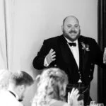 best man during speech at wedding reception