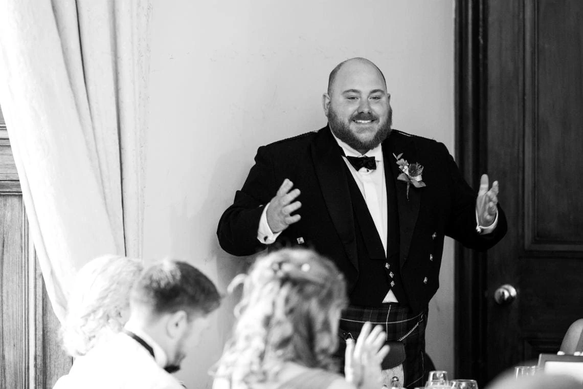 best man during speech at wedding reception