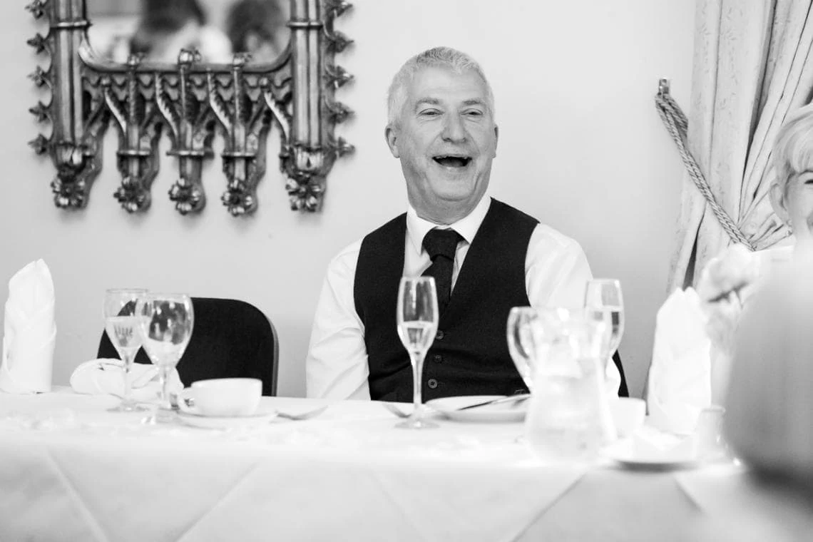 father of the groom laughing during speech