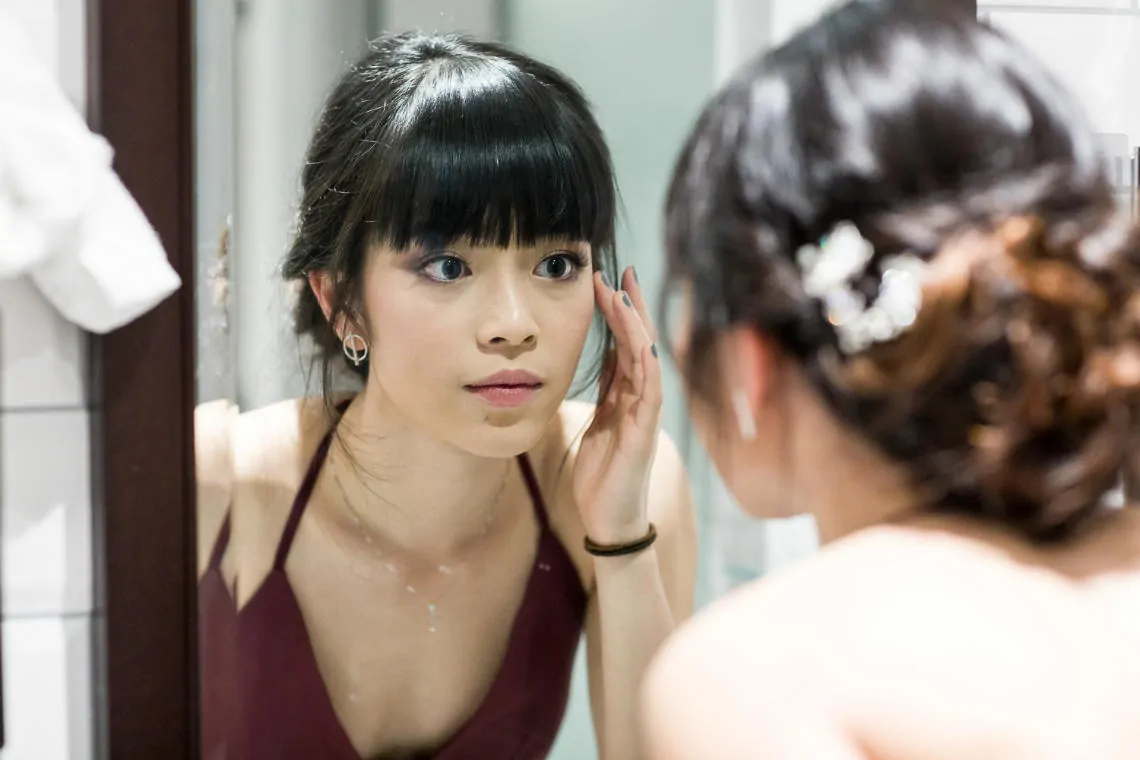 bridesmaid mirror reflection applying makeup