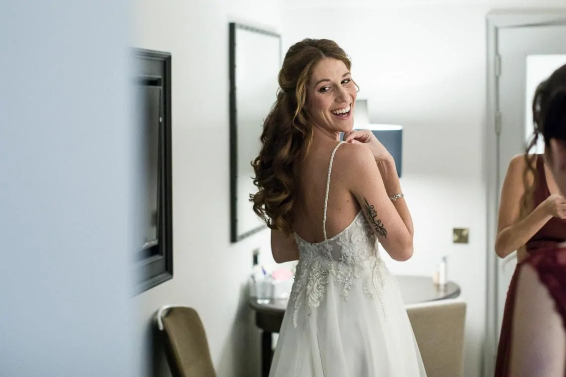 bride lookinmg at the back of her wedding dress in a mirror