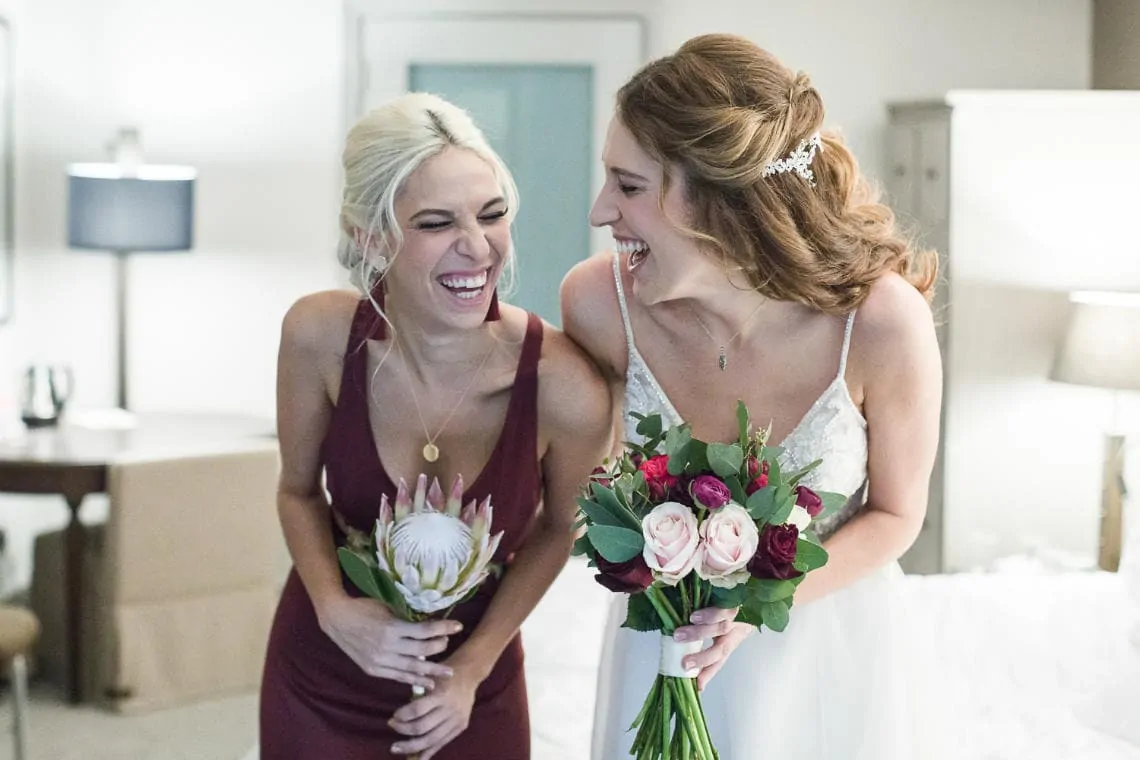 bride and her sister laughing
