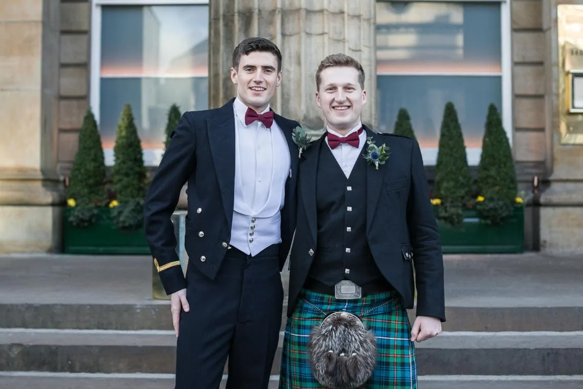 groom and best man on the steps outside The Dome