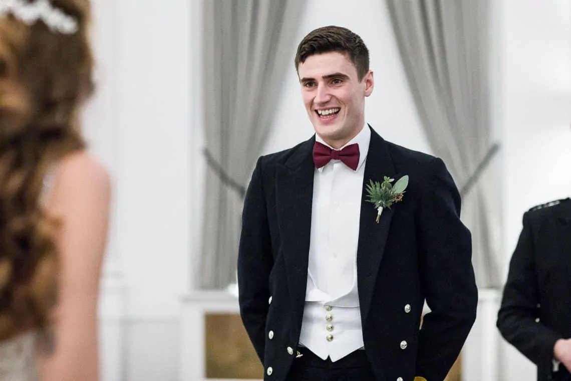 groom smiles at his bride
