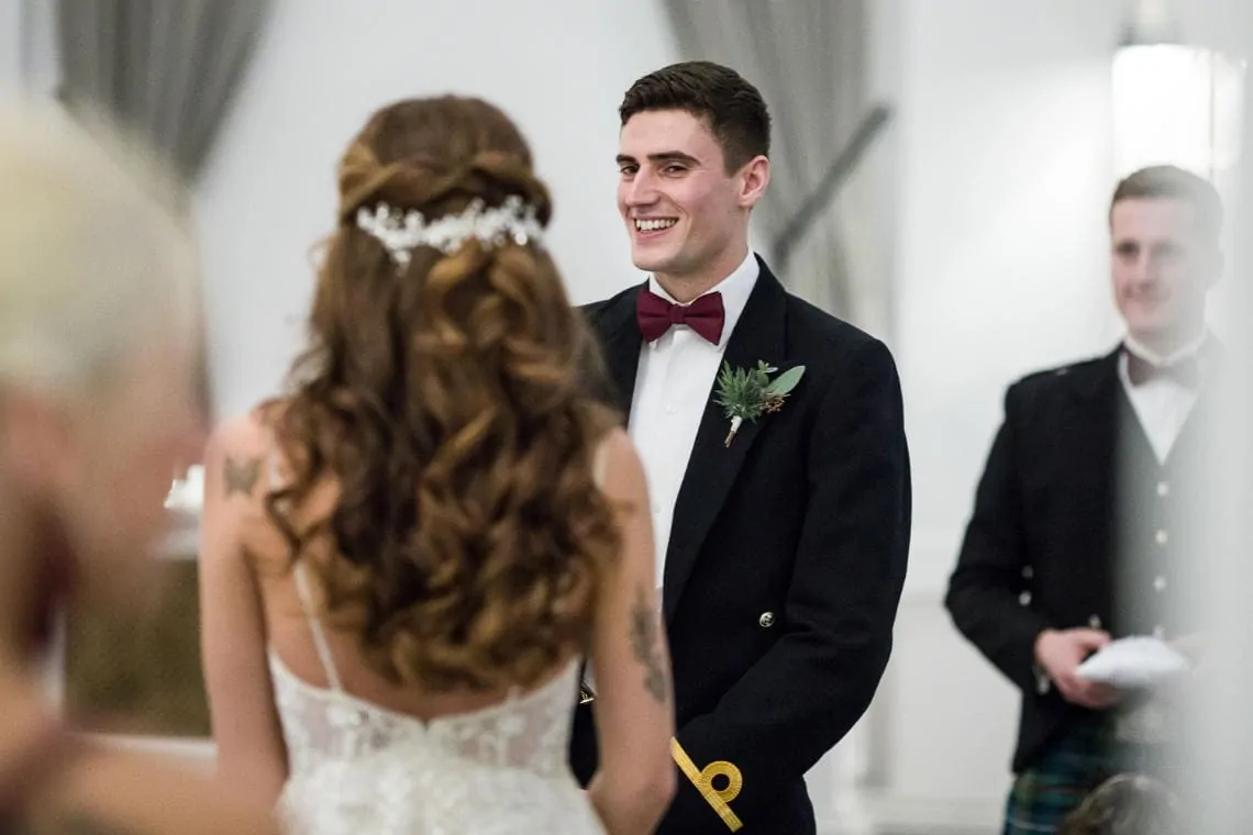 groom smiling during the marriage ceremony