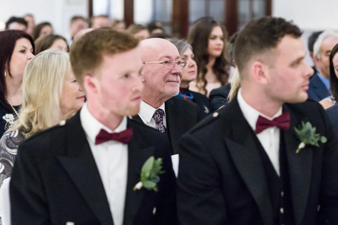 guests watch bride and groom exchange marriage vows