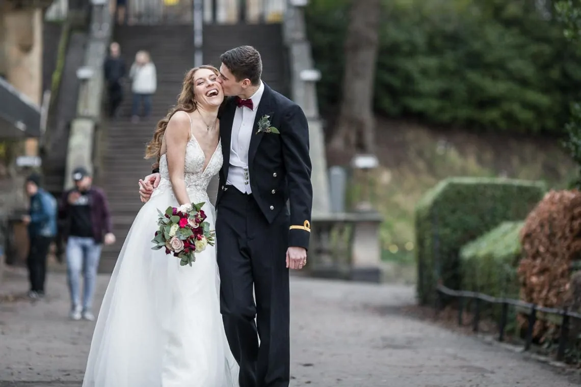 newlyweds walking together in Princes Street Gardens