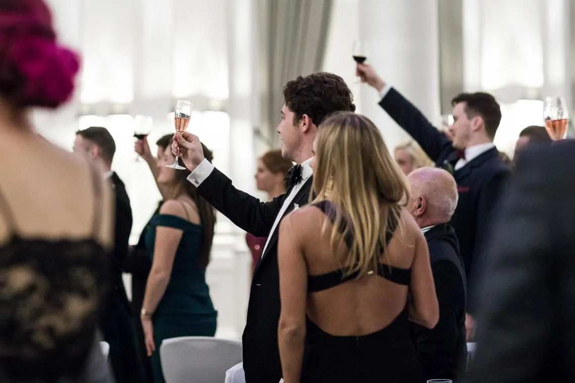 guests toast the newlyweds at the end of the best man's speech