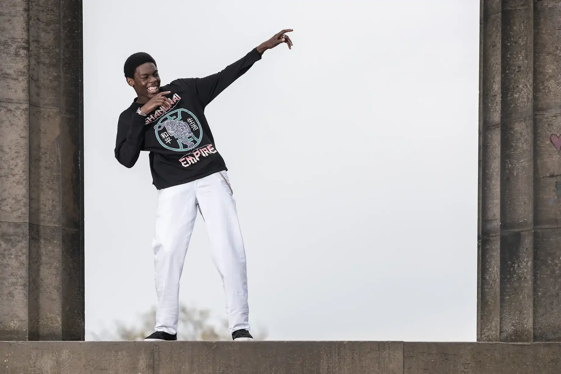 teen male strikes a pose on Calton Hill during a photoshoot