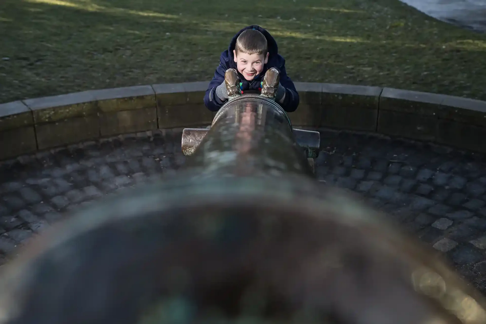 young boy on the cannon at Calton Hill