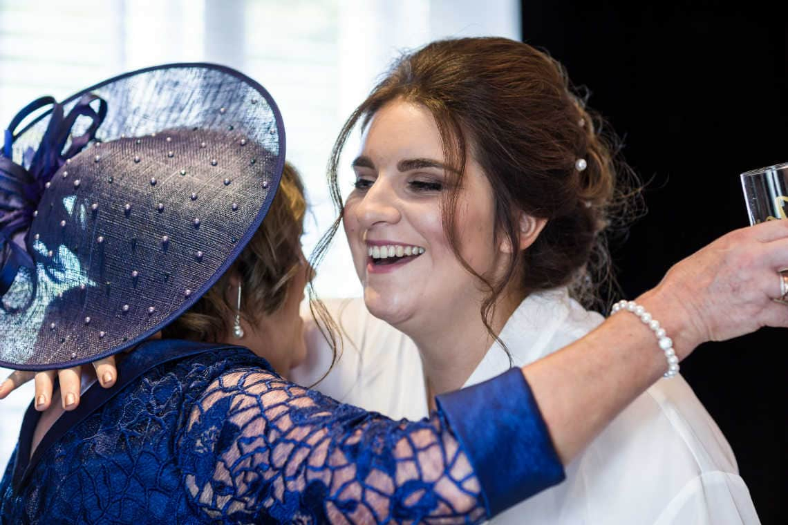 bride hugged by mother of the groom