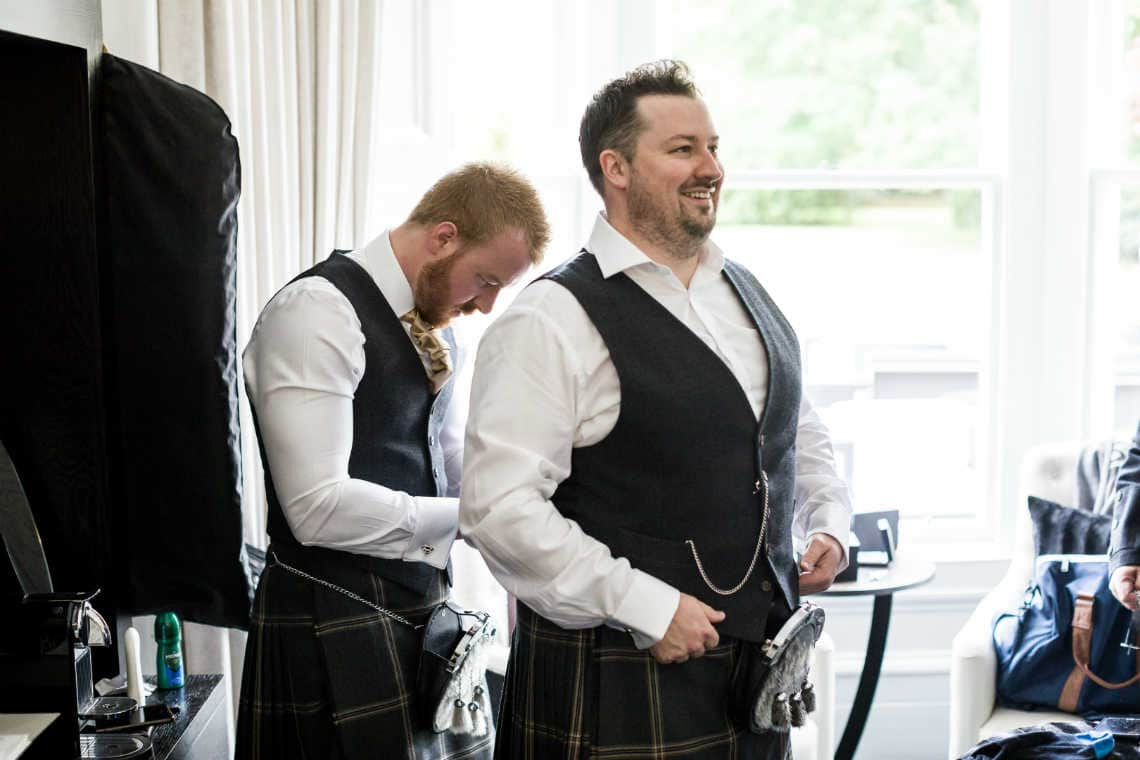 groom laughs during preparations