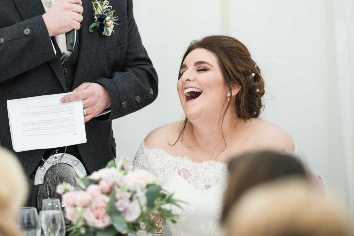 bride laughs during speech