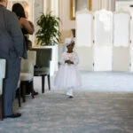 flower girl walking up the aisle at The Pompadour