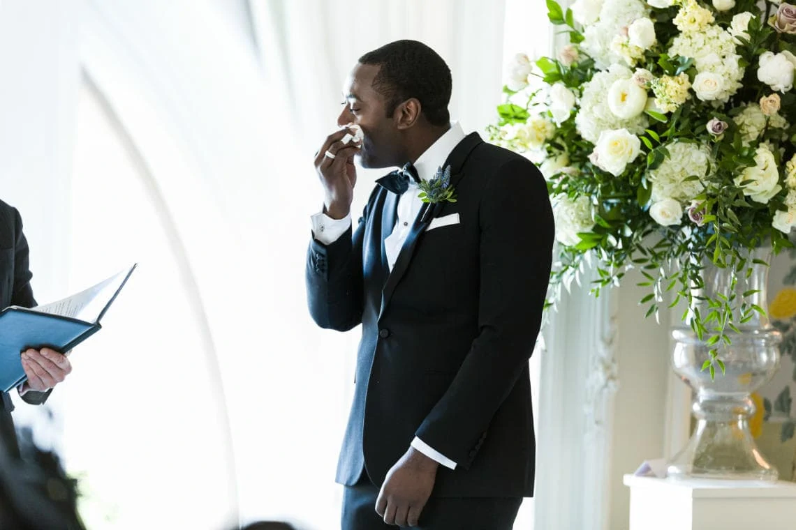Groom wipes a tear during Humanist ceremony