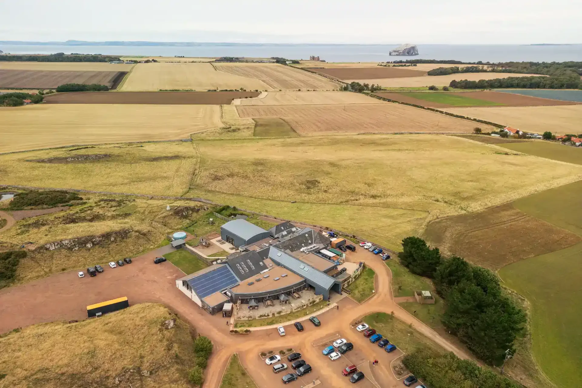 Whitekirk Hill wedding venue aerial drone view in summer, with the Bass Rock in the Firth of Forth in the background.